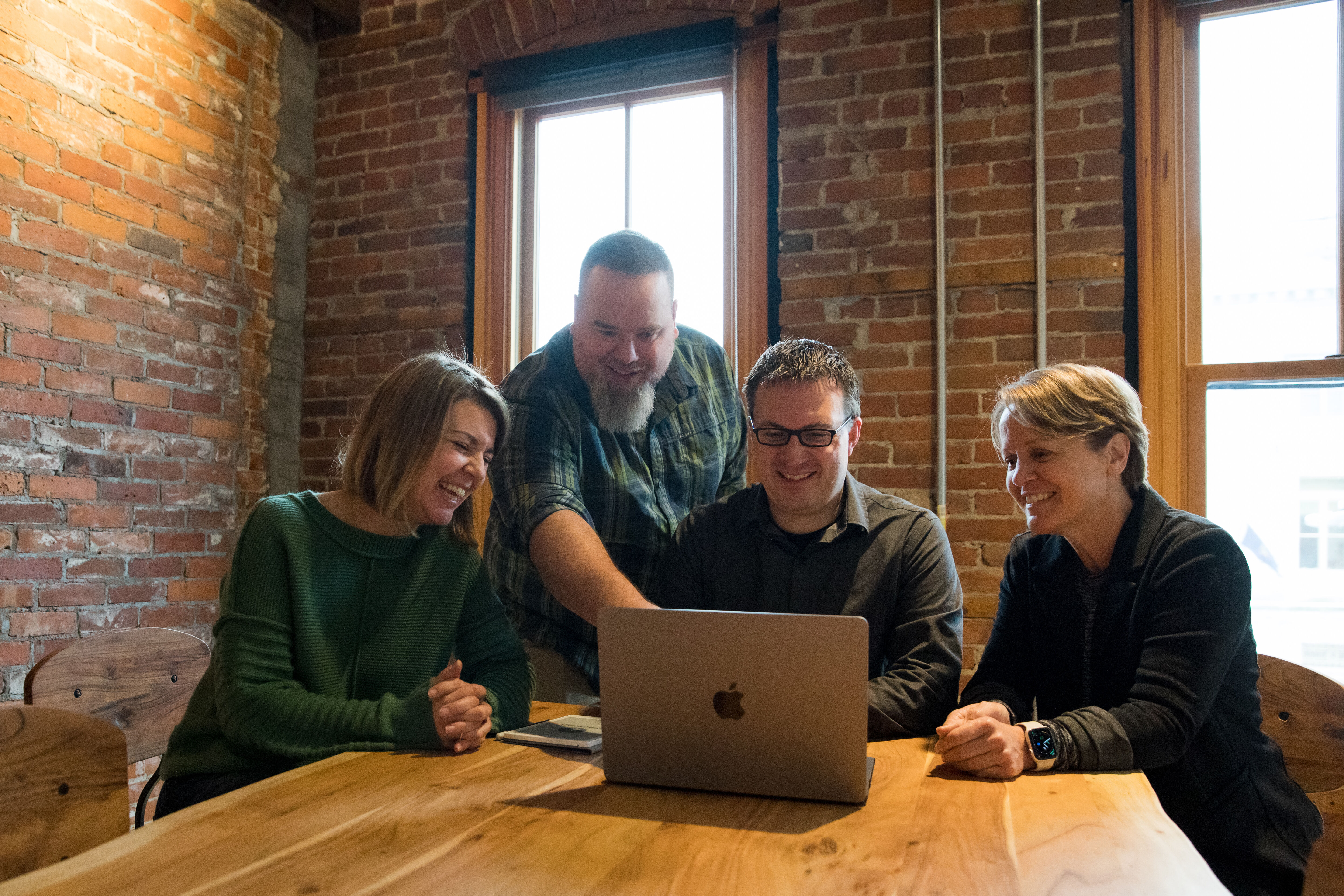 Eternity Team and Client meeting around a laptop at a table