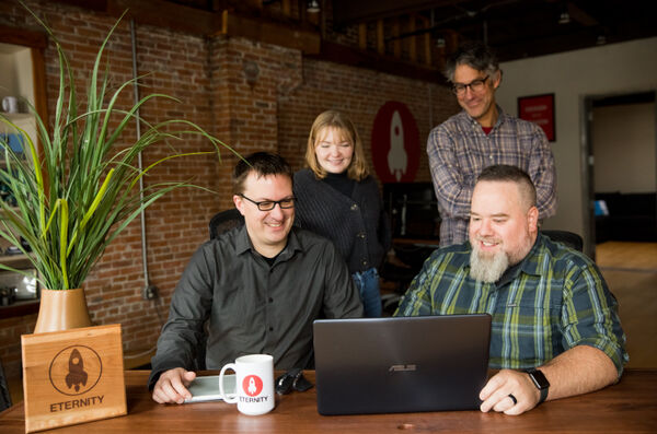 front end team looking at a laptop